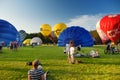 VILNIUS, LITHUANIA - JULY 3, 2020: Colorful hot air balloons taking off in Vingis park in Vilnius city on summer evening. Lots of Royalty Free Stock Photo