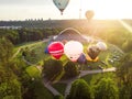 VILNIUS, LITHUANIA - JULY 3, 2020: Colorful hot air balloons taking off in Vingis park in Vilnius city on summer evening. Lots of Royalty Free Stock Photo