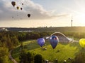 VILNIUS, LITHUANIA - JULY 3, 2020: Colorful hot air balloons taking off in Vingis park in Vilnius city on summer evening. Lots of Royalty Free Stock Photo