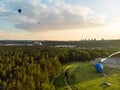 VILNIUS, LITHUANIA - JULY 3, 2020: Colorful hot air balloons taking off in Vingis park in Vilnius city on summer evening. Lots of Royalty Free Stock Photo