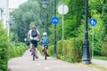 Father and son cycling on the bike road with blue road sign or signal of bicycle lane Royalty Free Stock Photo