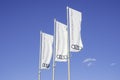 Vilnius, Lithuania - 20 June, 2022: White flags with Audo logo over blue sky. Audi AG is a German automobile