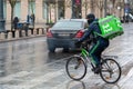 Rider with bike and mask under the rain working for Bolt Food