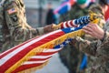 United States Marine Corps soldiers roll up American flag, USA Royalty Free Stock Photo