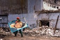 Vilnius, Lithuania-March 03, 2017: worker is carrying poster of Alain Delon in background of demolished movie theatre