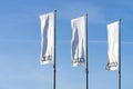 Vilnius, Lithuania - 11 May, 2021: White flags with Audo logo over blue sky. Audi AG is a German automobile manufacturer