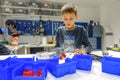 Vilnius, Lithuania - November 23, 2018: Kid making Lego robot mindstorms. Robotic, learning, technology, stem education