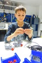 Vilnius, Lithuania - November 23, 2018: Kid making Lego robot mindstorms. Robotic, learning, technology, stem education