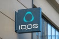 Vilnius, Lithuania - October 16, 2021: IQOS store signboard in Vilnius, Lithuania. IQOS is tobacco heating system