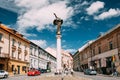 Vilnius, Lithuania. People Resting Near Statue Of Angel Blowing Royalty Free Stock Photo