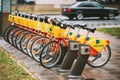 Vilnius, Lithuania. Row Of Colorful Bicycles AVIVA For Rent At Municipal Bike Parking In Street. Summer Day After Rain Royalty Free Stock Photo