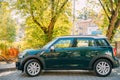 Front View Of Green Color Mini Cooper Car Parking At Street