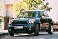 Front View Of Green Color Mini Cooper Car Parking At Street