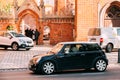 Green Color Mini Cooper Car Moving At Street With Female Driver