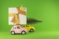 Vilnius, Lithuania - September 09, 2019: Little retro toy model cars with present gift box and small Christmas tree on