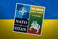 Vilnius summit NATO. Logo NATO summit, which will be held in Vilnius in July 2023 against the background of the flag of Ukraine