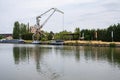 Vilvoorde, Flemish Brabant, Belgium, Crane and boats at an industrial site of the canal