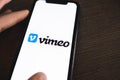 Vimeo logo on the smartphone screen.