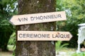 Vin d`honneur and ceremonie laique wooden arrow with text sign rustic wedding concept pointing for ceremony location means in