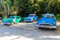 VINALES, CUBA - FEB 18, 2016: Vintage taxis at the entrance to Cueva del Indio cave in Vinales valley, Cub