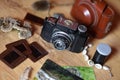 Vinatge camera with photos and souvenirs Royalty Free Stock Photo