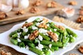 Vinegar and oil green bean salad recipe. Delicious green string beans salad with cottage cheese, peeled walnuts, garlic and spices Royalty Free Stock Photo