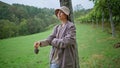 Vineyard farmer enjoying plantation at autumn. Woman holding grape cluster Royalty Free Stock Photo