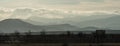 Vineyard in the shade against the mountains and clouds in the rays of the setting sun Royalty Free Stock Photo