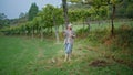 Vineyard worker relaxing green plantation wearing panama. Woman eating grape Royalty Free Stock Photo