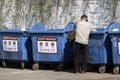 Tramp looking for food and things of garbage containers Royalty Free Stock Photo