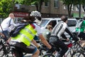 Cat on the shoulder of the owner takes part in the bike ride