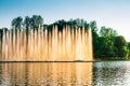 Vinnitsa, Ukraine. Color fountain on the lake in summer sunny day. Dancing fountain on green park background. Fountains show Royalty Free Stock Photo