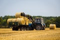 Vinnitsa,Ukraine - July 26,2016.huge tractor collecting haystack Royalty Free Stock Photo