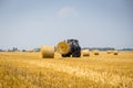 Vinnitsa,Ukraine - July 26,2016.huge tractor collecting haystack Royalty Free Stock Photo