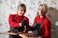 Girls waitresses with steaks. Medium-roasted steak cut into pieces on a wooden board with sauce and seasonings. Beef steak on wood