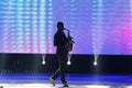 Figure of a man musician play saxophone on a stage in front of bright led screen in a pause during Miss Vinnytsia Beauty Contest Royalty Free Stock Photo
