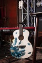 Yamaha acoustic guitar on stand, synthesizer on stage of Royal Pub, custom made instrument ready for rock