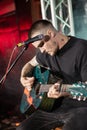 Zhenya Halych singer sing lyrical song and play acoustic guitar on stage of Royal Pub, Faine Misto festival, frontman of O.Torvald