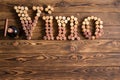 Vino cork letters with bottle of wine on wood Royalty Free Stock Photo