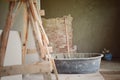 Vintage abstract picture of tools and cement cart mixer with the plastering wall at the construction site Royalty Free Stock Photo