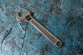 Vintage adjustable spanner on a blue background Royalty Free Stock Photo