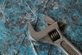 Vintage adjustable spanner on a blue background Royalty Free Stock Photo
