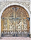 Vintage aged brown old wooden gate in brick wall Royalty Free Stock Photo