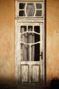 Vintage, aged door with a window panel. Royalty Free Stock Photo