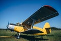 Vintage aircraft on green grass and blue sky background in sunlight. Old retro airplane Royalty Free Stock Photo