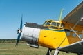 Vintage aircraft on green grass and blue sky background in sunlight. Old retro airplane Royalty Free Stock Photo