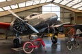 Vintage aircraft Lockheed 12A Electra surrounded by vintage bikes