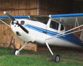 Vintage aircraft in wooden hanger. Royalty Free Stock Photo