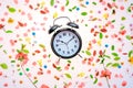 Vintage alarm clock flat lay with colorful springtime decoration Royalty Free Stock Photo