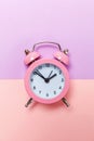 Vintage alarm clock Isolated on purple pink pastel background Royalty Free Stock Photo